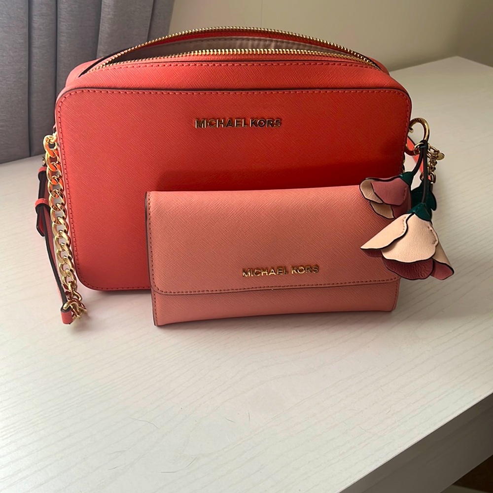 Peach Michael Kors cross body with matching pink wallet and rose charm